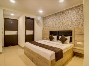 
a hotel room with a bed and a dresser at Hotel Dakha International Karol Bagh Newly Modified in New Delhi
