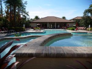 a swimming pool in a resort with a building at Premium Villa at Champions Gate in Kissimmee