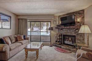a living room with a couch and a fireplace at Beaver Run 4308 in Breckenridge