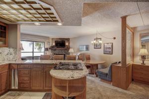 a kitchen with a stove and a living room at Beaver Run 4308 in Breckenridge