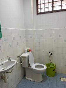 a bathroom with a toilet and a sink at LEPAK-LEPAK HOMESTAY @ INDERA MAHKOTA in Kuantan