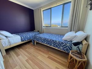 A bed or beds in a room at Freycinet Dream