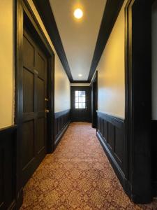 an empty hallway with a door and a window at Cecil Bacon Manor in Seattle