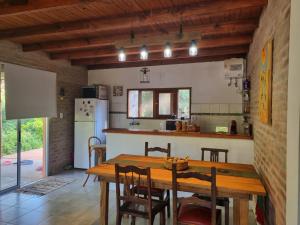 a kitchen and dining room with a wooden table at ROSALIMON in Nueva Palmira