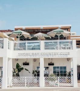 a white building with umbrellas on top of it at 814 Shoal Bay Waterviews in Shoal Bay +7 photos