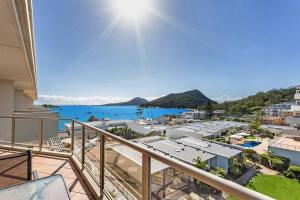 an apartment balcony with a view of the ocean at 814 Shoal Bay Waterviews in Shoal Bay