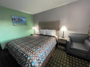 a hotel room with a bed and a couch at Travel Inn in South Lake Tahoe