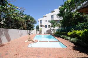 a swimming pool in front of a building at 18 Ipanema Beach in Durban