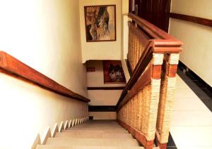 a staircase in a building with wooden railings at Room in Lodge - Prince Of Anthony 1960 Hotel-apartment in Lagos