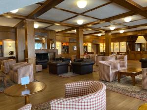 a lobby with couches and tables and chairs at Luxury private studio in Paradiso Verde in Bansko