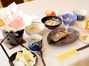 a white table with plates of food on it at Apprising hotels GranJam Tsugaike in Otari