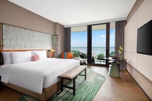 a bedroom with a large bed and a large window at Hotel Indigo Suzhou Yangcheng Lake, an IHG Hotel in Suzhou