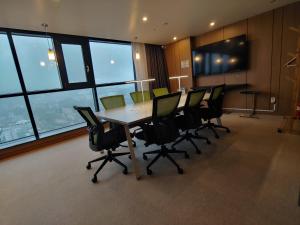 a conference room with a table and chairs in an office at Hotel The Designers Seoul Station in Seoul