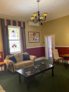 a living room with a couch and a coffee table at Avon Terrace Guest House in York