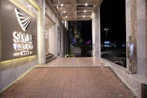 a walkway with a sign on the side of a building at Skyline Tabuk Hotel in Tabuk