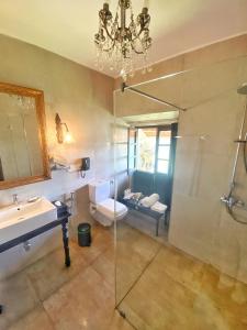 a bathroom with a sink and a glass shower at Fort Tiracol Goa in Arambol