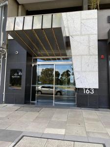 a building with a car in the front door at Modern Quiet 1 & 2 Bed Apt Opposite Albert Park in Melbourne