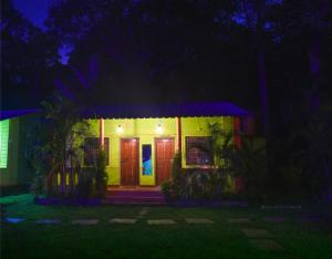 a house with lights on the front of it at night at Dandeli Eco VanaVasa by StayApart in Dandeli