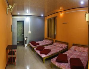 a room with three beds in it with a hallway at Dandeli Eco VanaVasa by StayApart in Dandeli