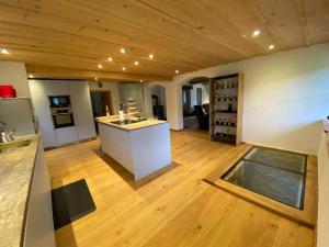 a large room with a kitchen with a counter top at Ferienhaus Pottmeyer in Kollnburg