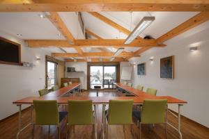 a conference room with a long table and chairs at Bükkös Hotel & Spa in Szentendre