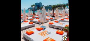 a group of beds with umbrellas on a beach at Arcadia in Odesa