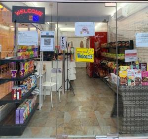 a store aisle of a grocery store with a welcome sign at SBS HOTEL in Padang Besar