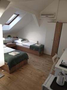 a bedroom with two beds in a attic at Pribina Penzión in Nitra +41 photos