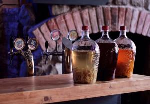 three bottles of alcohol sitting on a wooden table at 2-room Apartment NFT Gudauri Penta 701 in Gudauri