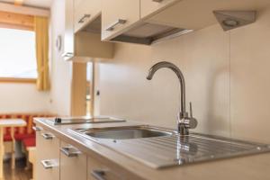 a kitchen with a sink and a counter top at Runcac Apt Gomina in San Vigilio Di Marebbe +16 photos