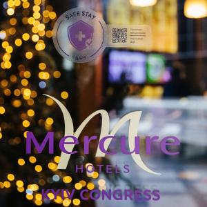 a sign on a door of a restaurant with a christmas tree at Mercure Kyiv Congress in Kyiv
