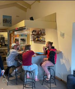 people sitting at a table in a restaurant at Cooroona Alpine Lodge in Falls Creek