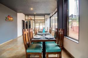 a dining room with a long table and chairs at Mountain Breeze Resort, Mahabaleshwar in Mahabaleshwar