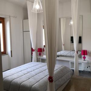 a bedroom with a bed and a large mirror at Babbo maison in Guidonia