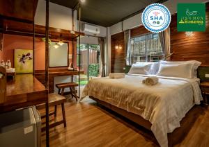 a bedroom with a large bed with a desk and a desk at Ingmon House in Chiang Mai