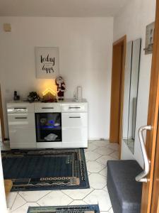 a living room with a white fireplace in a room at Konnis FerienHaus in Speichersdorf