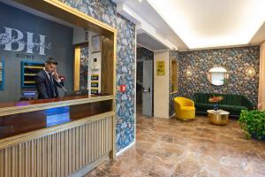 a man talking on a phone in a hotel lobby at Bloom Hotel Rome in Rome