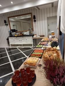 a buffet line with many different types of food at "Arkadia" in Ostrołęka