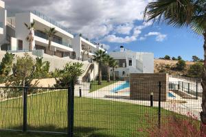 a fence in front of a building with a yard at Martormar in Finestrat