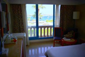 A bed or beds in a room at Marina Sharm Hotel