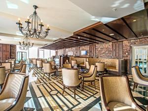 a restaurant with chairs and a chandelier at Elite World Istanbul Florya in Istanbul