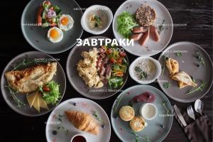 a bunch of plates of food on a table at Hotel "VITAMIN" in Krasnodar