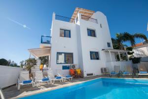 a villa with a swimming pool in front of a house at Villa Saint Nikolas in Protaras