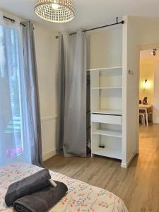 1 dormitorio con cama y espejo grande en LE DUMON 2 - T2 avec GARAGE - TERRASSE - WiFi - Gare à 200m, en Agen
