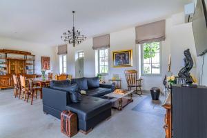 a living room with a couch and a dining room at Vila Brinovka in Kostanjevica na Krasu