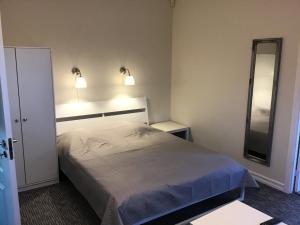 Кровать или кровати в номере Apartamentai Naglis