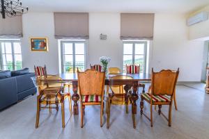a dining room with a table and chairs at Vila Brinovka in Kostanjevica na Krasu