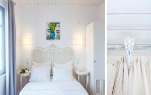 a white bedroom with a white bed with white pillows at Ela Tenedos Hotel - Special Category in Bozcaada