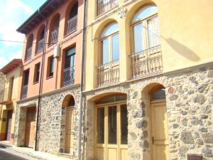 a building with windows and doors on a street at El Balco del Llierca in Sant Jaume de Llierca