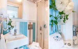 a bathroom with a sink and a vase of flowers at Ela Tenedos Hotel - Special Category in Bozcaada